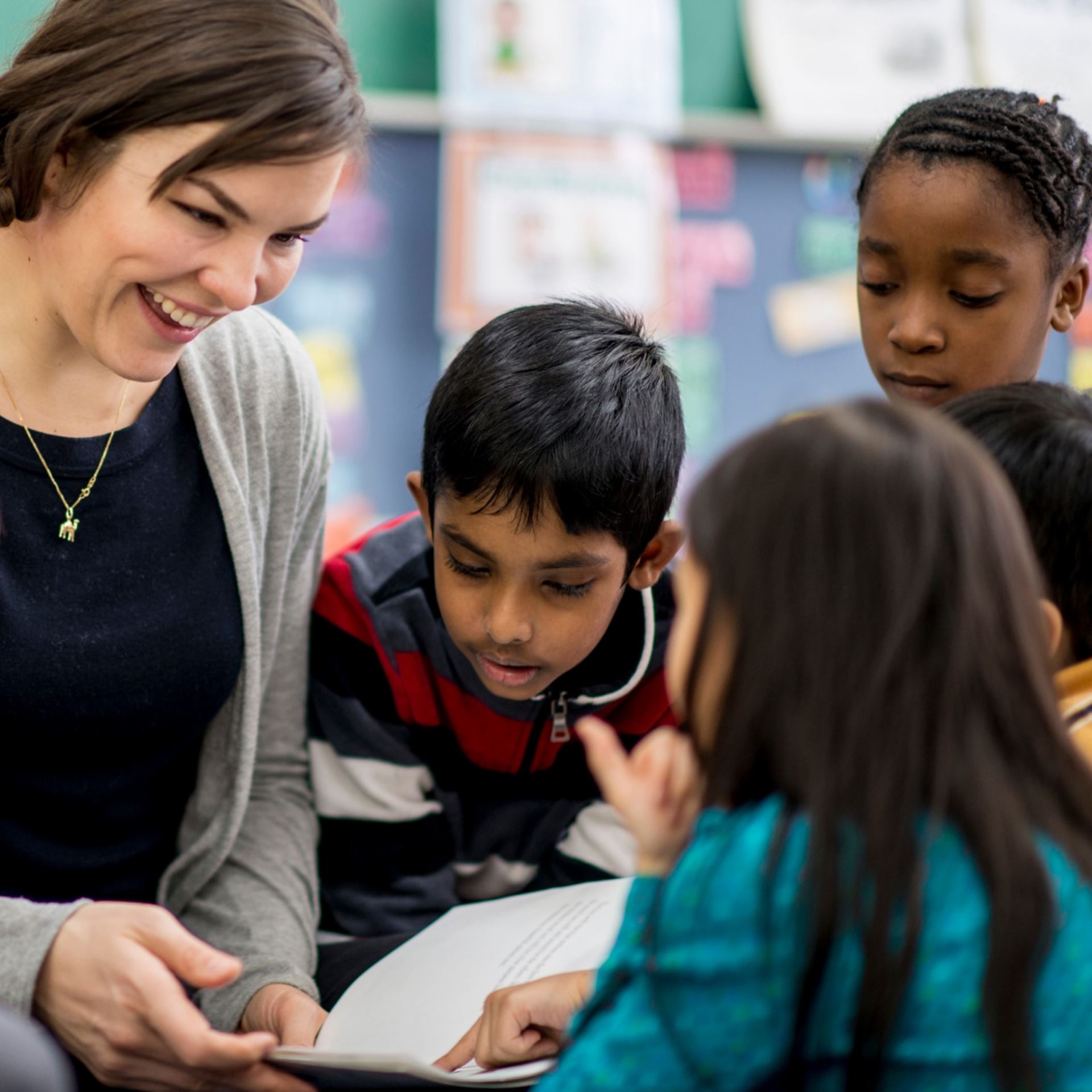 Teacher and young students sitting in a circle